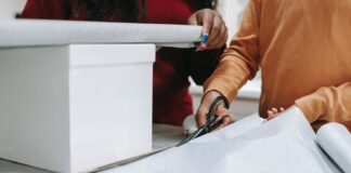 사용하지 않는 장난감 교회로 가져오세요 photo of a person s hands cutting wrapping paper